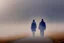 Placeholder: two people seen from behind walking side by side in an empty foggy plain, above there is blue sky