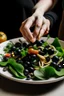 Placeholder: A plate of salad and pasta, with hands placing black olives on top of them