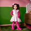 Placeholder: a 4 years old azeri girl in modern clothing and makeup standing pose with cute and joy with pertty boots in a baby bedroom