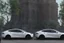 Placeholder: A Tesla 'Model 3' is parked, near the 'Statue of Liberty' in New York. CINEMATIC. WIDE ANGLE LENS. PHOTO REAL.