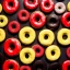 Placeholder: Yellow and red and black donuts on a black table