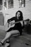 Placeholder: beautiful woman playing acoustic guitar in mid west blck and white old photto