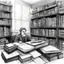 Placeholder: [a chaotic pen sketch with a lot of strokes in stippling] a man in a library surrounded by books and papers