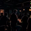 Placeholder: a single figure in a crowded bar at night, dark colors