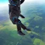 Placeholder: detailed matte painting of a ferret wearing a jumpsuit with parachute harness jumping out of a plane, skydive, sunlit sky, intricate, ultra-fine detailed, 8k, high-quality, 3d, realistic, midjourney style