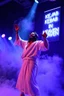 Placeholder: An "Kebab man" performing at dance club, his name is "Kebab man" and looks crazy, Jesus on stage, White and light blue Neon lights and smog, "KEBAB IN HEAVEN" SIGN ON WALL