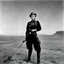 Placeholder: [art by Russ Meyer] Lee Miller stands with her camera in the battlefield. she shows off her garters. This war photographer is a fascinating figure indeed. She captured powerful images during World War II, showcasing the realities of conflict with a unique perspective. Her work is a testament to the courage and artistry of photojournalists in documenting history.