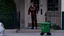 Placeholder: UPS delivery man in green crocs is at the gate