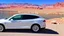 Placeholder: A Tesla's 'Model S Plaid' is parked, at the 'Lake Mead', in Nevada. CINEMATIC. WIDE ANGLE LENS.