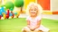 Placeholder: A cute little girl, curly blonde hair, the look on her smiling face.