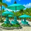 Placeholder: A greenish blue island resort with parasols designed in Hawaiian tiki statues painted by Diego Rivera