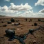 Placeholder: Photograph, objects scattered over an arid surface, noon-light, clouds, tv studio, nothingness, close-up, in Yves Tanguy style, nightmare, highly hypermaximalist, details of the terrain very accentuated, 8k, deep 3d field, sharp, eerily mysterious, artistic photo, large format film, shot on Hasselblad, 33mm photography, mysterious, dark, rotten, macabre, streams of black liquid