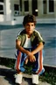 Placeholder: eleven year old mediterranean boy dressed track pants, early 80's color photo