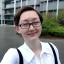 Placeholder: A short haired, female computer engineer taking a selfie in front of Building 92 at Microsoft