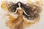 Placeholder: Dynamically dancing long haired brunette woman, in Klimt style, in ochre, watercolor and ink, golden glitters