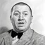 Placeholder: a captivating portrait illustration of Curly Howard, his frustrated countenance dominating the canvas, wild eyes piercing through enveloping darkness, palpable textures, detailed line work, opulent shadows, hyperrealistic