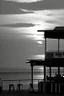 Placeholder: Terraza de un chiringuito frente a la playa al atardecer, fotografía realizada con una cámara Leica y con un objetivo de 50 mm, fotografía real, fotografía en blanco y negro