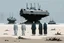 Placeholder: (((three)) long-legged lean determined black-grey monks with ((beak-shaped heads)) (wearing white khiton) standing in front of a tank wreck on a radioactive beach, front view, acrylic painting, minimal art, centered, wild sparse brushstrokes, amazing verticals, great parallels, low bleak colors of gray, blue and black, excellent negative space contrasts