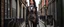 Placeholder: full-height portrait of a woman with straight shoulder-length black hair, with metal arms and legs, dressed in leather trousers, and a waistcoat, in a Victorian street next to a steampunk bike