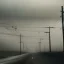 Placeholder: An empty road on a misty day. Telegraph poles and wires. Muted tones. Tilted high horizon. With blotches, blurry areas and lens noise and grain. Photo 4k