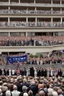 Placeholder: donald trump standing on a balcony with hundreds of people below kneeling