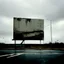 Placeholder: Minimal contemporary abstract oil paintings of desolate 1960s carpark with road markings and concrete fragments. Overlay with grungy typography graphics. style of Justin Mortimer and Francis Bacon.