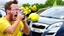 Placeholder: guy in hurricane arguing on phone next to his kia sportage made out of lemons