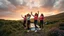 Placeholder: a group of young ladies in sports pants and blouse are dancing to camera in high grassy hills,a small fall and river and wild flowers at river sides,cloudy sun set sky