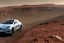 Placeholder: A Tesla 'Model S' is racing at top speed, at the Cydonia region on Mars. (CINEMATIC, WIDE ANGLE LENS, PHOTO REAL)
