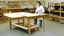 Placeholder: lady standing behind a unassembled table