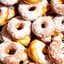 Placeholder: a polka dot pattern of carnival mini donuts with hole in the middle covered in white powder