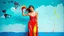 Placeholder: a woman in acrylic paint, pouring paint on herself in the style of an artistic dress, full figure in a natural setting, a ruined sky blue wall, photo, intriguing colors, paint pain with prompts