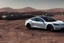 Placeholder: A Tesla 'Model S' is drifting at high speeds, in Mos Eisley on the planet Tatooine. (CINEMATIC, WIDE ANGLE LENS, PHOTO REAL)