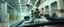 Placeholder: car driving happy 2d fluffy alien bunny ogre man in the style of Escher and Giger and Fallout 4, pinhole cam, airbrush 3d rendering, on tv screen:A five-second cinematic single take in a clean industrial presentation hall.