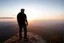 Placeholder: a brawny man with grey hair views sunset from a cliff