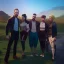 Placeholder: people posing in front of factory Simon Stålenhag style