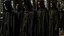 Placeholder: black robe hooded monks in the chapel