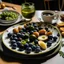 Placeholder: A plate of olives surrounded by breakfast