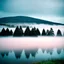 Placeholder: A polaroid photo of a group of fir trees in the background and a high hill in the distance. A lake. The surface below is in a pastel color. Fog is present.