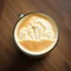 Placeholder: close up top-down view of a latte with a maximal Seattle city skyline formed in the milky foam, professional photography, looks like an advertising campaign photo, delicious