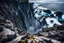 Placeholder: This mesmerizing ocean cliff scene captures the dramatic power and beauty of nature. Towering rugged cliffs stand majestically against the vast expanse of the ocean, where the water pours into a singular bottomless pit. The cliffs, with their sharp and jagged edges, create a stark contrast to the rough, flowing water, making the scene even more captivating. Sunlight pierces through the mist rising from the waterfalls, creating a magical, ethereal atmosphere
