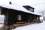 Placeholder: Snowy cabin in the mountains in the snow storm with a scary atmosphere