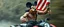 Placeholder: hi speed bad ass cyber punk masculine realistic mickey mouse rambo humanoid with hairy arms and chest, on quad, motion blurred background, holding american flag