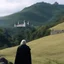 Placeholder: The lord of the Hell on the right, looking at the camera. A landscape with his castle on a hill in the background.