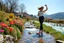 Placeholder: country side over high heels in spring wind slowly moves color full flowers,clean water fall and narrow river with waves and pretty rocks in floor ,some trees and houses ,and mountains at distant,a very beautiful Turkish lady wearing tight pants and blouse salsa dancing , full body shot