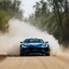 Placeholder: dramatic epic photography ralli art championship supercar race, facing front supercar ,full sticker name DV race decorations,on the way high speed drifting and jumping,on dune and watery spray and dirt roads forest