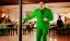 Placeholder: man in a green suit in a restaurant with purple lights, dancing on a pole