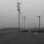 Placeholder: An empty carpark on a misty day. Telegraph poles and wires. Muted tones. Tilted horizon. With blotches, blurry areas and lens noise and grain. Hyper realistic Photo 4k