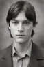 Placeholder: 1920's yearbook photo, teenage Daryl Dixon (Norman Reedus) 14 years old, brown hair, 1920's hairstyle and clothes, photorealistic, --ar 9:16 --style raw