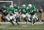 Placeholder: Boston Shamrocks Football team playing against the Toronto Rifles Football team, vintage, hyper-realistic, in color, tv broadcast